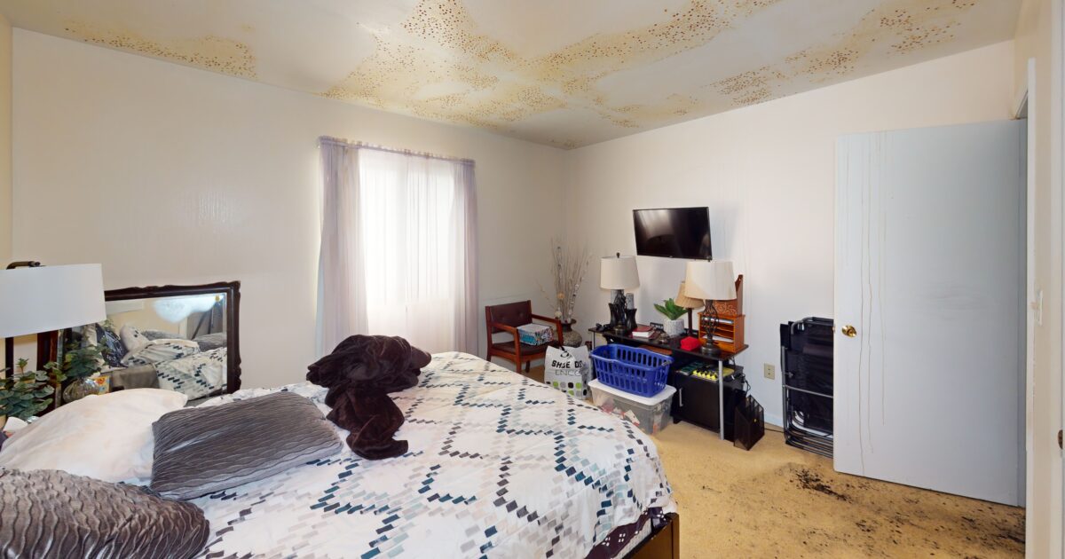 A ceiling with water damage before Swartz Restoration mitigated the water issue.