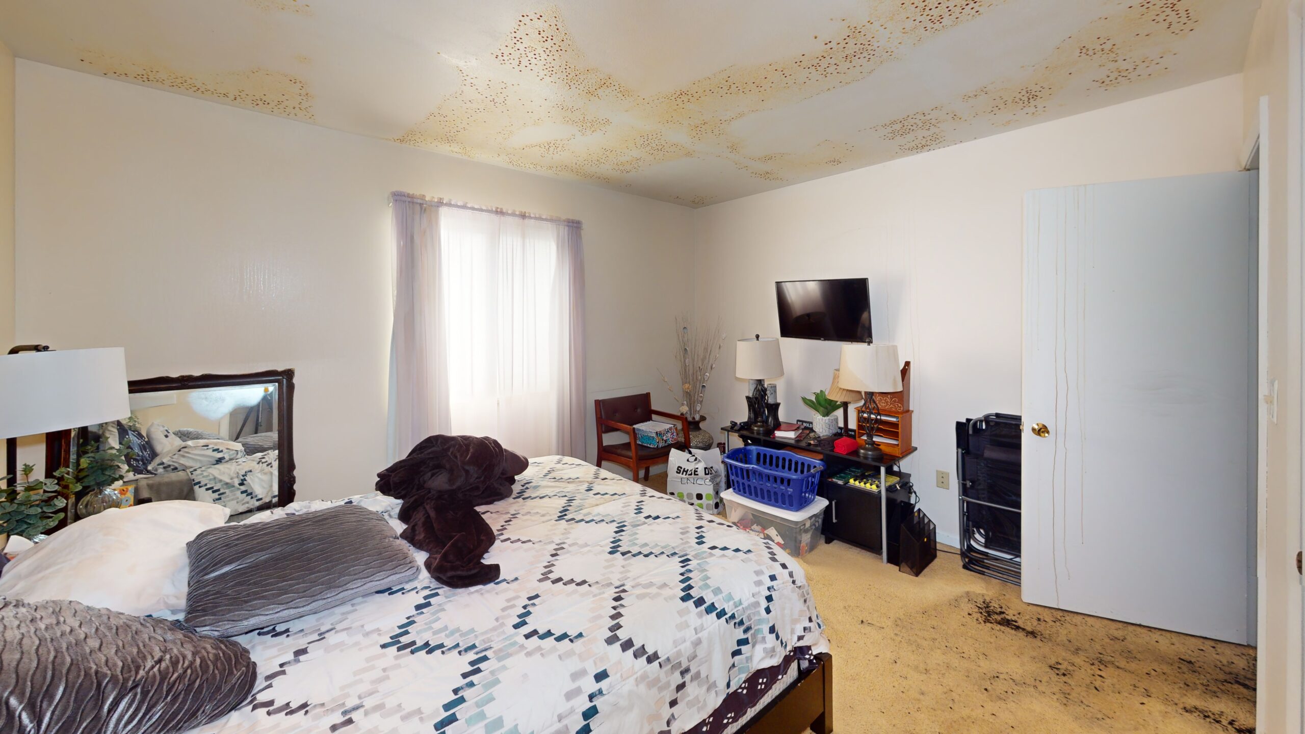 A ceiling with water damage before Swartz Restoration mitigated the water issue.